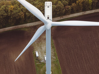 Wind turbine with opened hatch. A worker prepares to go out for maintenance. The EU Green Deal and Zero Carbon Footprint