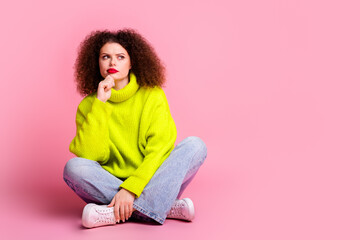 Full size photo of pretty young girl look skeptical empty space wear trendy yellow outfit isolated...