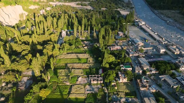aerial drone shot of a small village with vegetation in ladakh