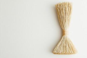 A straw broom on a white background.