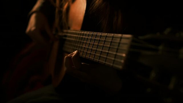 guitar neck, strings, cinematic, dark muted interior. guitar solo fingers on fretboard guitar player playing music