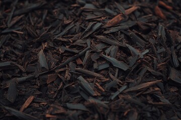 Textured dark brown organic mulch background