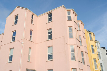 Colorful and vibrant generic multistorey apartment buildings against a bright blue sky