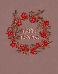 Happy Holidays inscription in a Christmas wreath. Christmas wreath with pine cones, red flowers and red polka dot ribbon