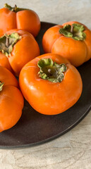 Close-up of several ripe persimmons.  Shot on mobile device.