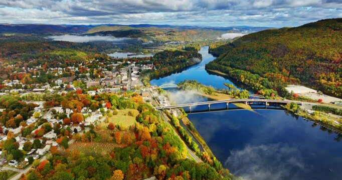 Autumn in beautiful Vermont, New England, USA. Aerial perspective on the city at the waterfront of a river.
