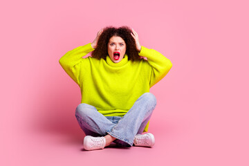 Full body photo of attractive young woman sit floor frightened reaction dressed stylish yellow clothes isolated on pink color background