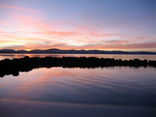 Orange, pink, purple and blue sunset reflection on Lake Tahoe California