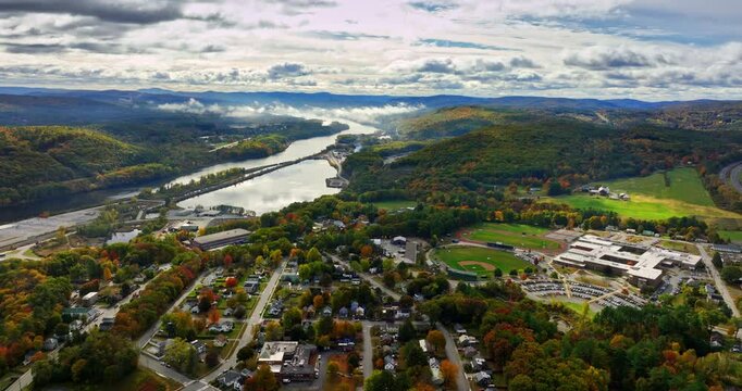 Dramatic clouds in the sky above the panorama of Vermont, New England, USA. Scenery of beautiful city and picturesque nature. Aerial view.