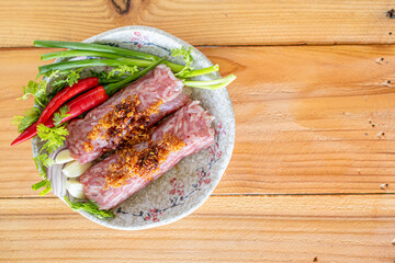 Minced pork rice garlic and spices are mixed together and wrapped in a stick form to marinate the food giving it a sour taste because it is a type of Asian food preservation called naem or sour meat.