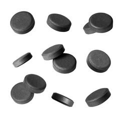 Set of activated charcoal pills isolated on a white background