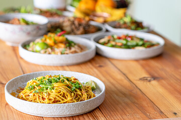 The Khao Soi Yuan Naan that is served on the plate is Khao Soi noodles mixed with minced pork spring onion coriander and chili lime and sesame spicy and sour. noodles chinese food tai yai food