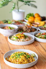 The Khao Soi Yuan Naan that is served on the plate is Khao Soi noodles mixed with minced pork spring onion coriander and chili lime and sesame spicy and sour. noodles chinese food tai yai food