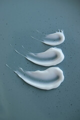 white cream on blue background.texture of white cream for face and body care
