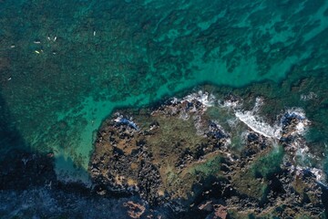 Sunrise in Wailea Maui Hawaii and a shallow blue reef in the pacific ocean.