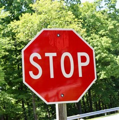 A close view of the red stop sign on the side of the road.