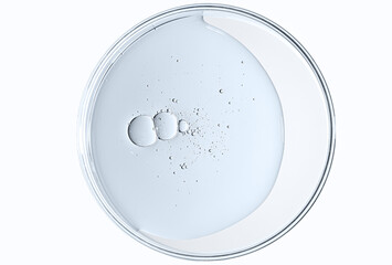 The texture of a cosmetic serum or body gel in a Petri dish.
