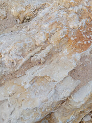 Close-up of natural stone texture with different shades of grey, brown and white. Natural cracks and patterns create a striking and unique texture.