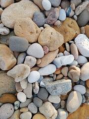Close-up of natural stone texture with different shades of grey, brown and white. Natural cracks and patterns create a striking and unique texture.