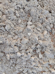 Close-up of natural stone texture with different shades of grey, brown and white. Natural cracks and patterns create a striking and unique texture.