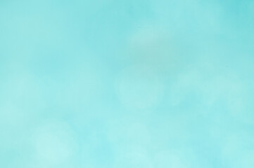 A light blue background with a subtle, faded texture