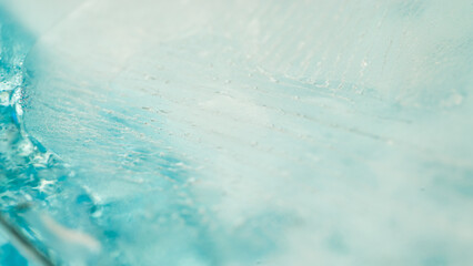 A close-up view of a clear, turquoise pool with ripples on the surface