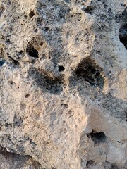 Close-up of natural stone texture with different shades of grey, brown and white. Natural cracks and patterns create a striking and unique texture.