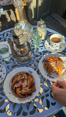 a fika spread of cinnanon buns and pastries with coffee at a charming Stockholm cafe, antique decor 