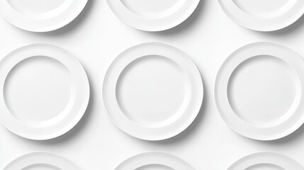 Set of white plates, each slightly overlapping, on a white background creating a neat, layered effect with shadows.