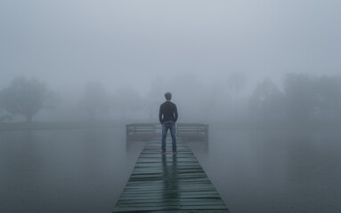 Person on the pier, thick mist.