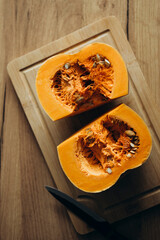 Pumpkin on a wooden cutting board is perfect for delicious fall recipes.