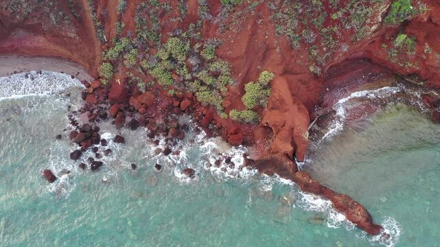 Maui red rock cliffs meet the blue Hawaiian ocean