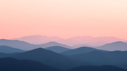 Obraz premium The misty mountains at sunrise are tinted pink and purple