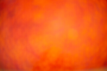 Hot lava. Fiery blurred background. Dark red-orange gradient bokeh background.
