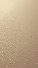 A smooth, light beige surface with a subtle, textured pattern.