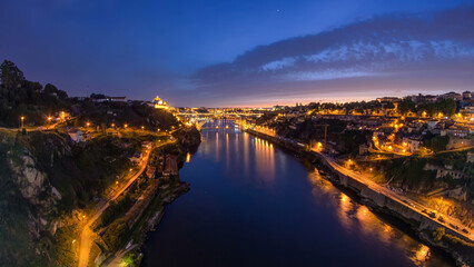 Day to night view of the historic city of Porto, Portugal timelapse with the Dom Luiz bridge