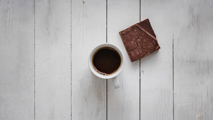 Minimalist Coffee and Dark Chocolate Pairing on White Wooden Surface
