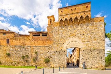 Naklejka premium The Porta San Giovanni, the main gate entrance into the Italian medieval hill town of towers, San Gimignano, Italy, in the Tuscany region.