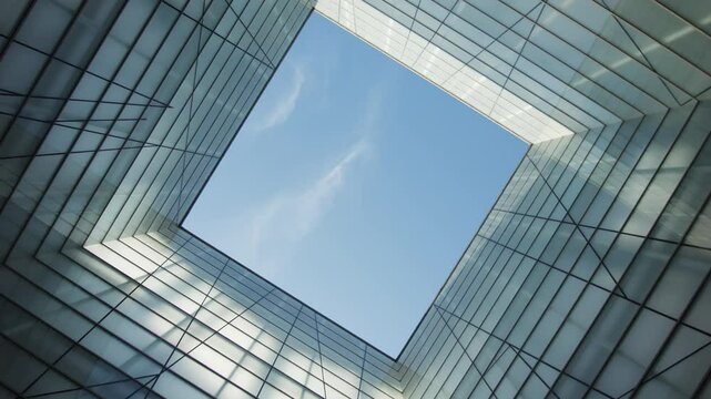 A Beautiful Modern Architectural Perspective Viewed from Below Against a Clear Blue Sky