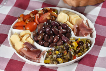 portion of olives with cheese cherry tomatoes and parma ham snack healthy food vegan salad