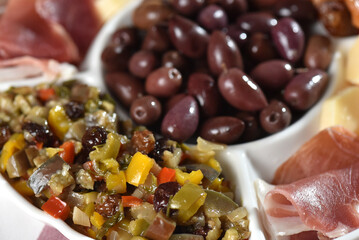 portion of olives with cheese cherry tomatoes and parma ham snack healthy food vegan salad