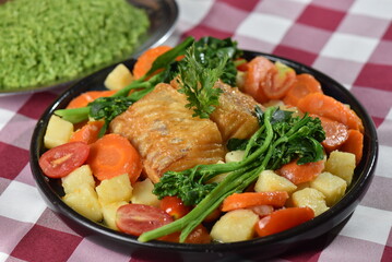 codfish typical Portuguese dish baked cod with onion garlic peppers and potatoes rustic Portuguese food salted fish cooked olive oil