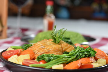 codfish typical Portuguese dish baked cod with onion garlic peppers and potatoes rustic Portuguese food salted fish cooked olive oil
