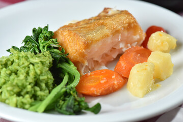 codfish typical Portuguese dish baked cod with onion garlic peppers and potatoes rustic Portuguese food salted fish cooked olive oil