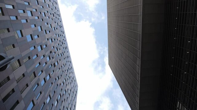 Modern glass office scyscraper buildings beautifully reflecting the clear blue sky in an urban environment