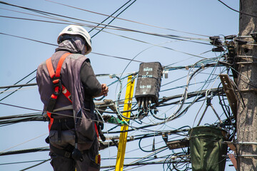 electrician doing maintenance on public lighting cables