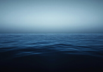 Obraz premium A single, large cloud hangs in the sky over a vast, blue ocean on a cloudy day