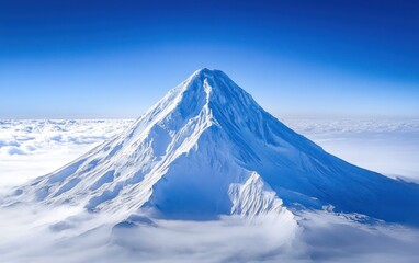 Photo of an isolated snow-covered volcano peak, with clear blue sky in the background