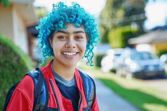 Vibrant blue-haired teen with backpack outdoors