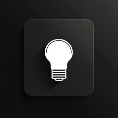 Light bulb icon on black square button, surrounded by modern office gadgets, suggests innovative solutions.